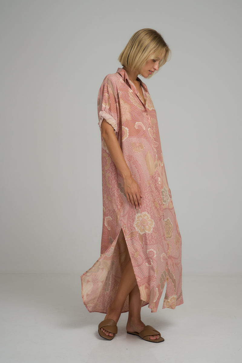 A woman wearing a pink floral maxi shirt dress in Australia