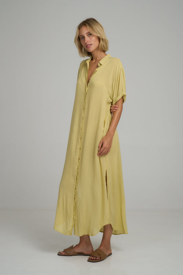 A model wearing a summer yellow cotton shirt dress