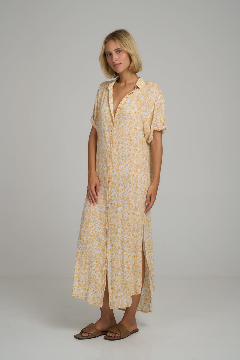 A model wearing a yellow maxi shirt dress in Australia