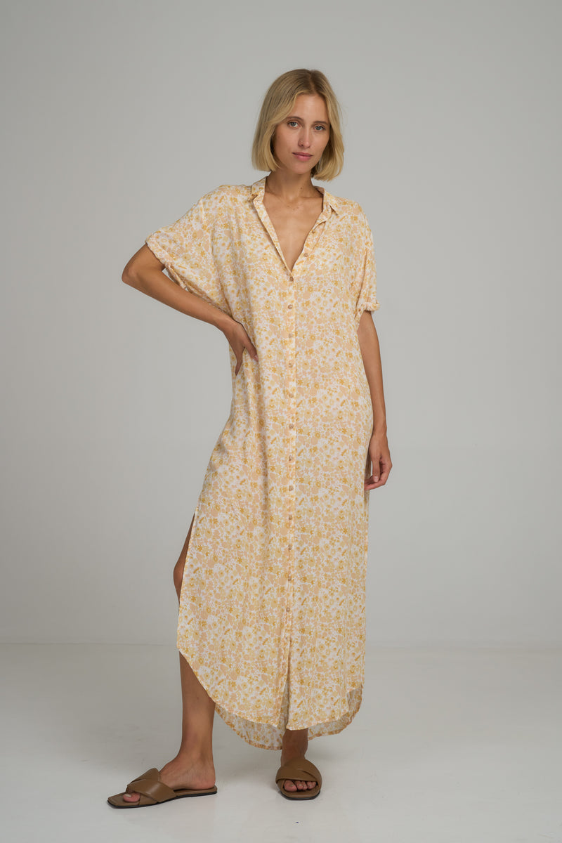 A model wearing a yellow floral maxi summer dress