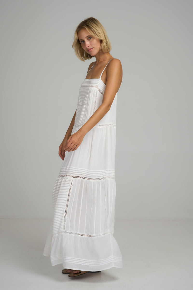 A model wearing a white summer cotton maxi dress