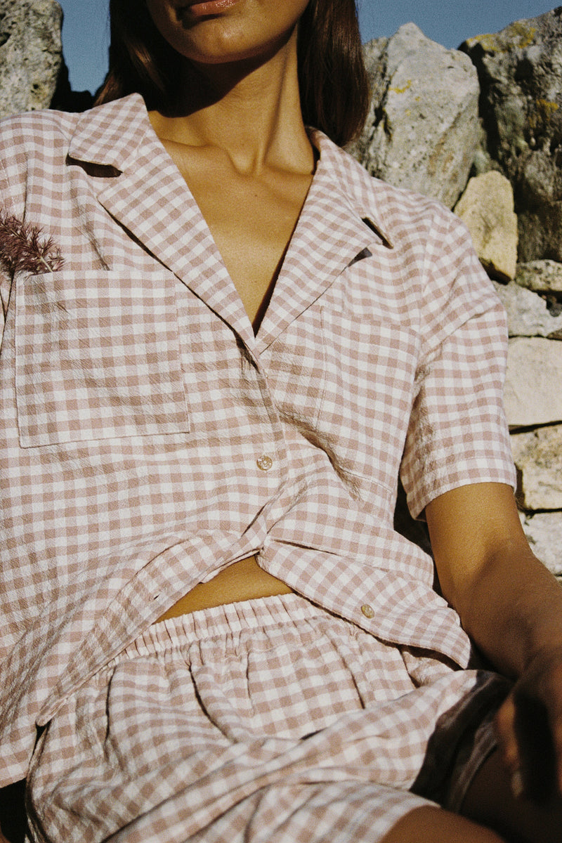 A model wearing a casual check shirt in Australia