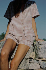  A woman wearing a beige check top