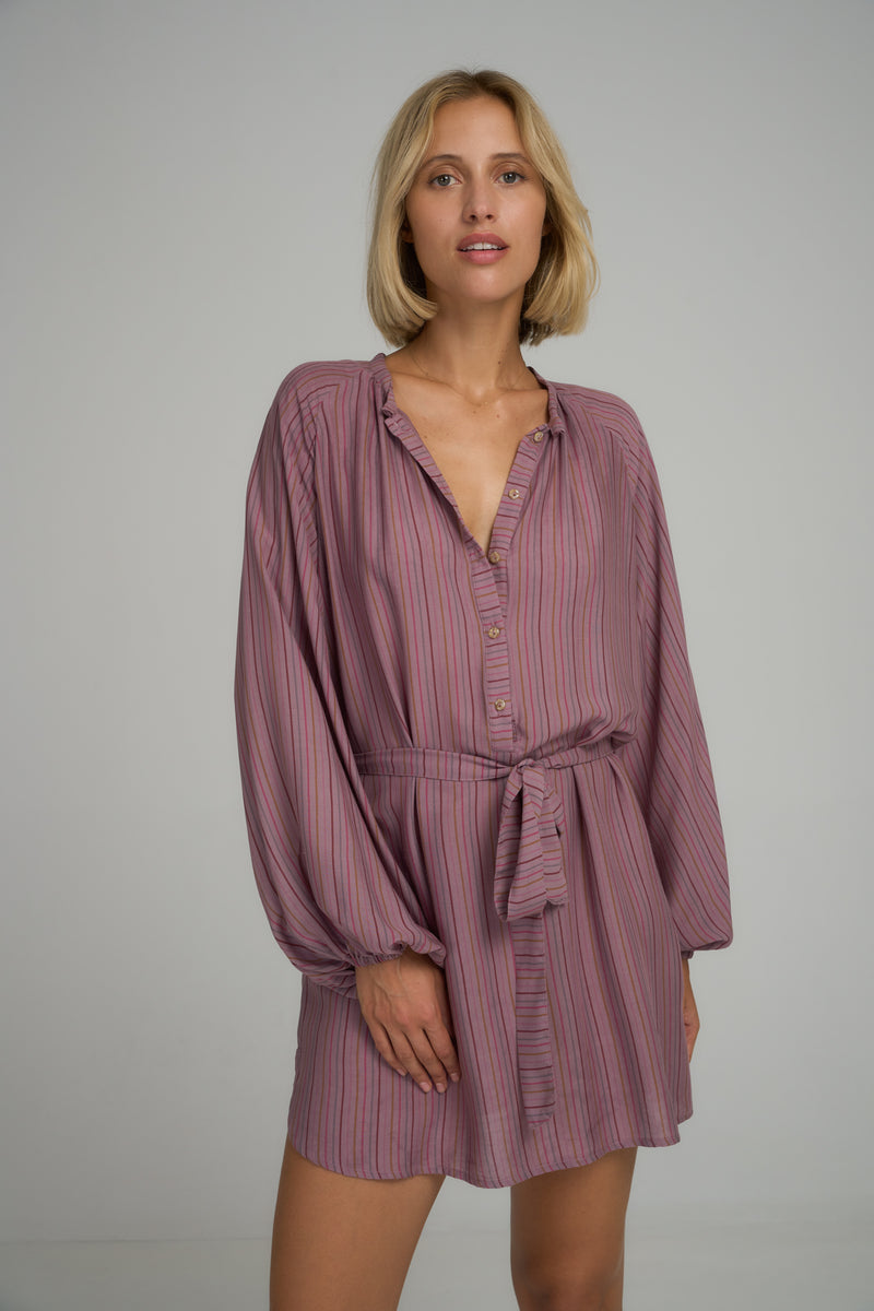 A woman wearing a purple stripe mini shirt dress for Summer