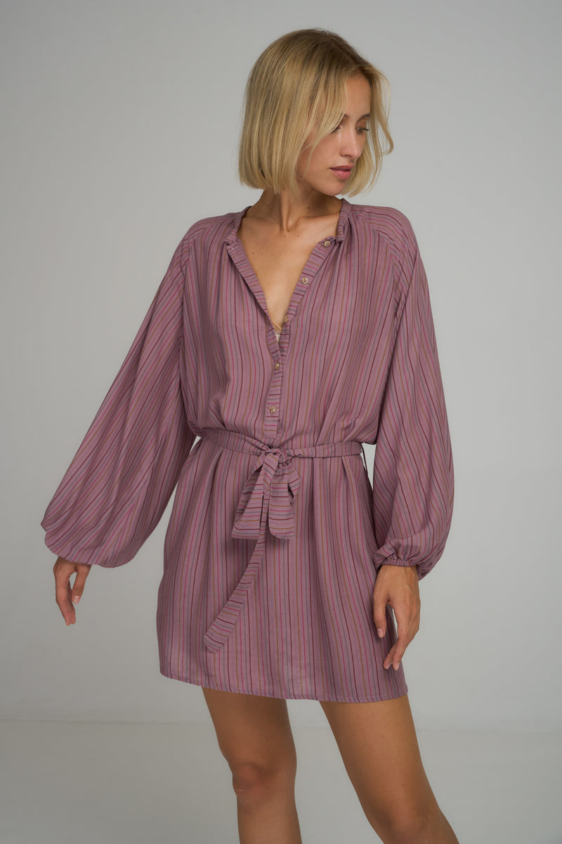 A woman wearing a lilac striped cotton mini dress in Australia