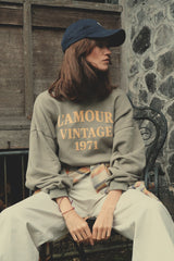 Model wears washed green oversized logo sweater by LILYA