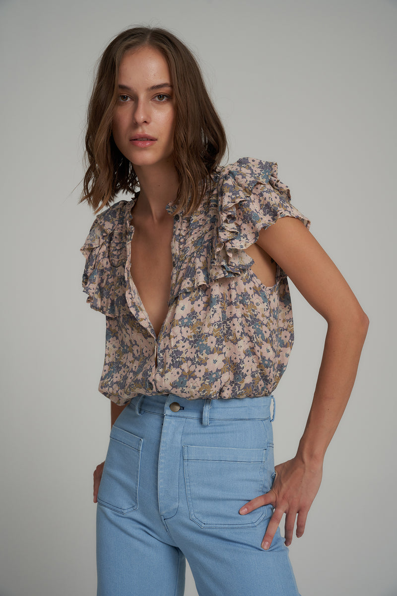 A Model Wearing a Short Sleeve Blue Floral Top
