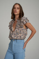 A Woman Wearing a Blue Floral Summery Top by LILYA