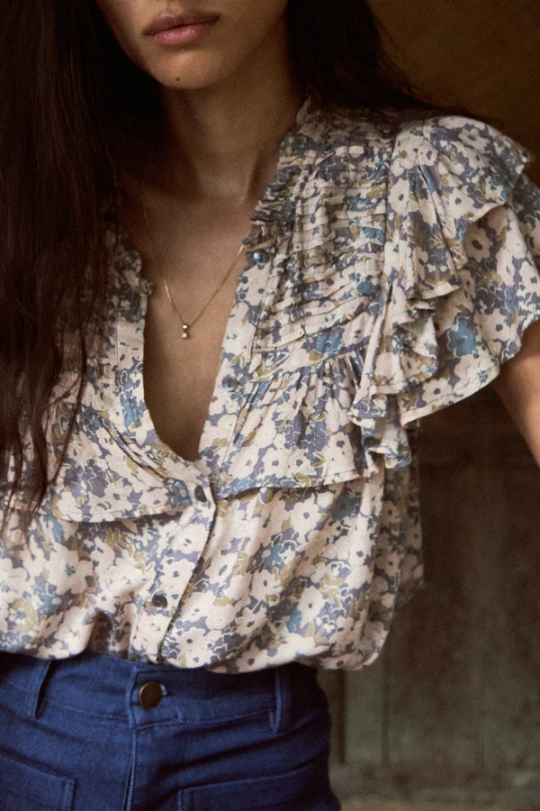 A Model Wearing a Blue Floral Summer Top