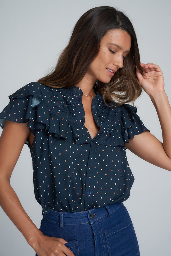 A model wearing a pretty navy blouse
