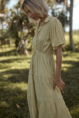 A model wearing a feminine yellow casual dress