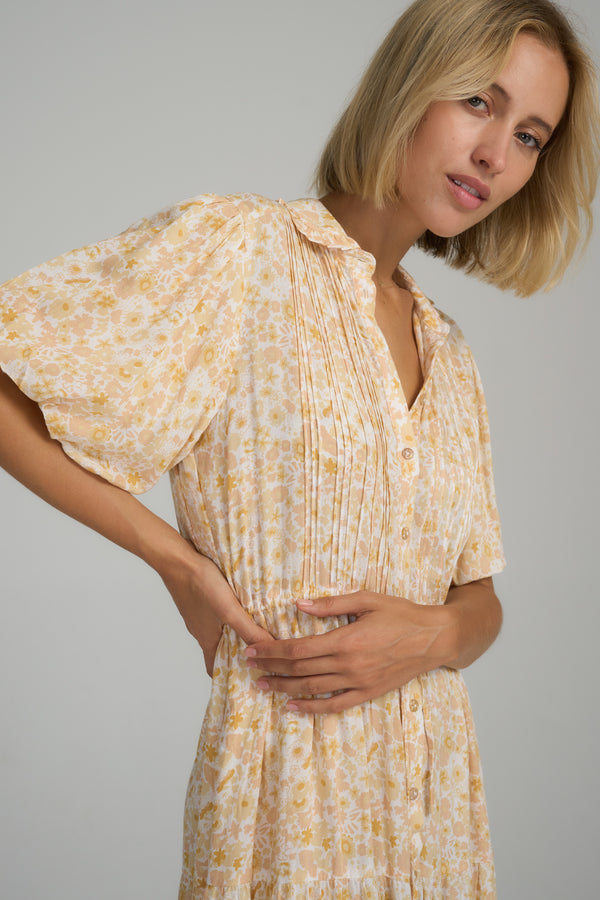 A model wearing a yellow floral midi dress