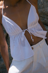 A model wearing a sexy white cotton summer top