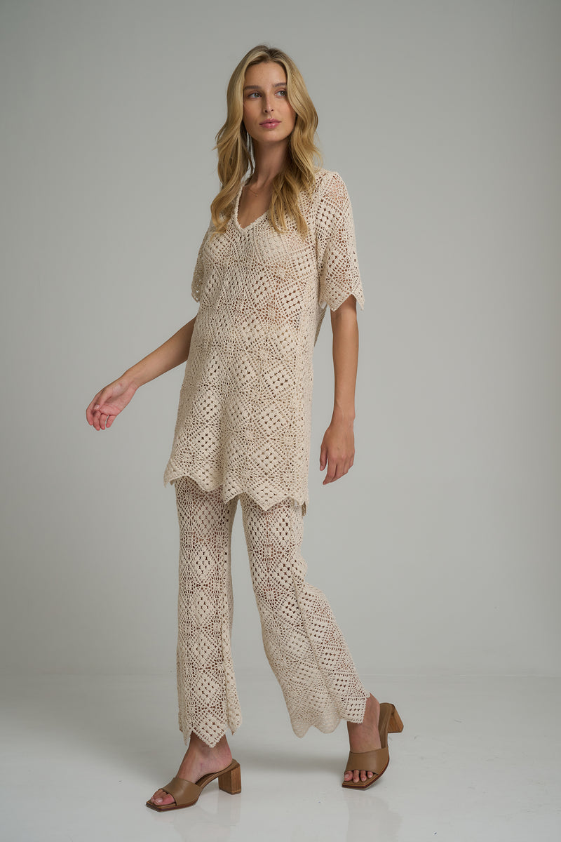 A model wearing lace ivory pants in Australia