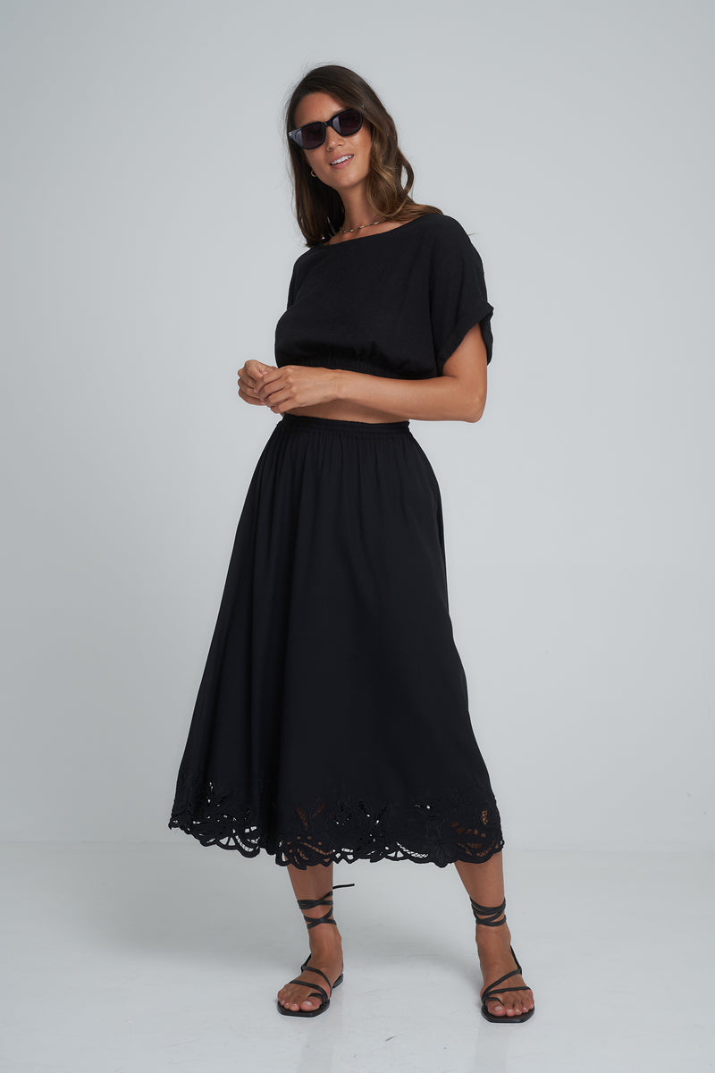 A Model Wearing a Black Cotton Midi Skirt with Lace Details