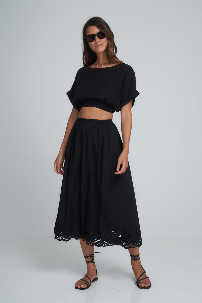 A Model Wearing a Black Midi Skirt with Lace Trim