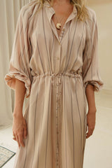 Model wears a stripe print shirt dress with drawstring waist