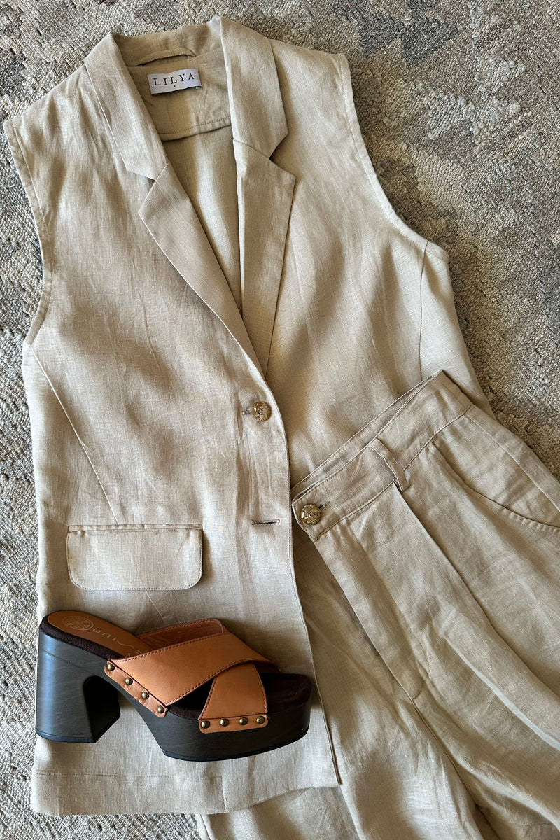 Flat lay of Malachite Vest by Lilya in linen sand colourway