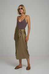 A model wearing a green silk midi wrap skirt