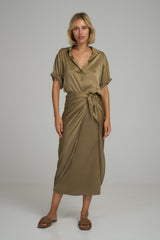 A woman wearing the Martini Silk Wrap Skirt in Moss Green by LILYA