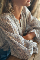 A close-up photo of the sleeves on the Mohave blouse by LILYA in the Provence floral print. 