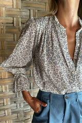 Close-up image of sleeves on Mohave Blouse with frill and tie detail in lightweight textured fabric. 