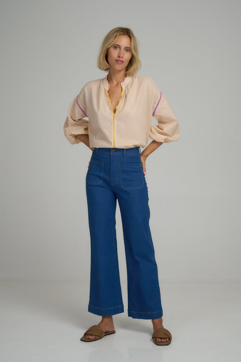 A woman wearing high waist denim jeans