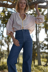 A model wearing 70's style dark denim jeans