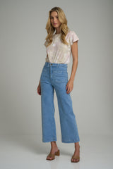 A woman wearing 70's inspired pale blue jeans