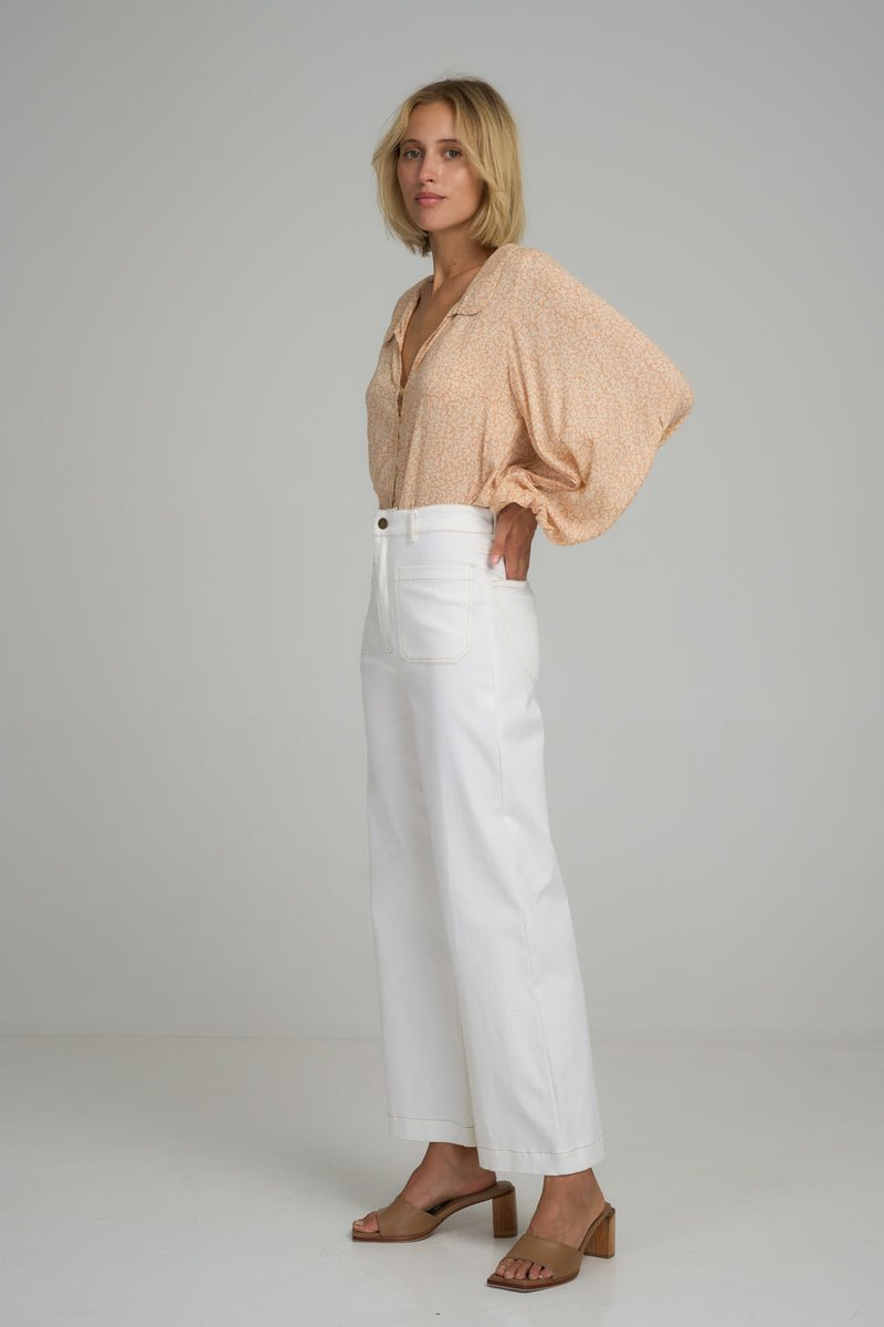 A woman wearing white cotton summer pants