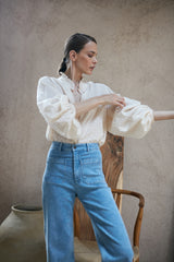 A model wearing high rise light blue jeans by LILYA