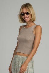 A model wearing a natural ribbed tank top