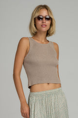 A model wearing a cropped natural knit top