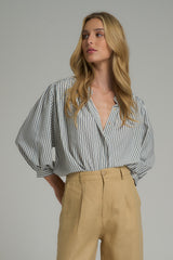 A model wearing a blue stripe work top