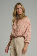A model wearing a floral top by LILYA in Australia
