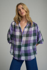 A woman wearing a cotton purple check top for winter