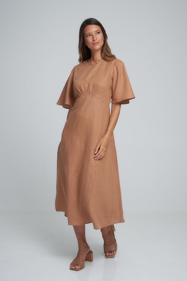 A woman wearing a brown linen mini dress