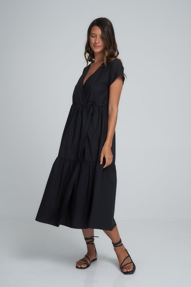 Side view of a classic black maxi wrap dress