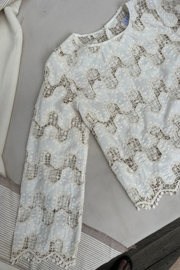 A flatlay image of the Norfolk Top Natural by LILYA