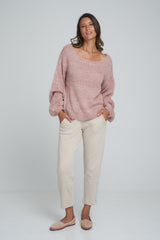 A model wearing a oversized pink and ivory sweater