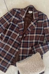 Flat lay image of brown check blazer for transeasonal styling