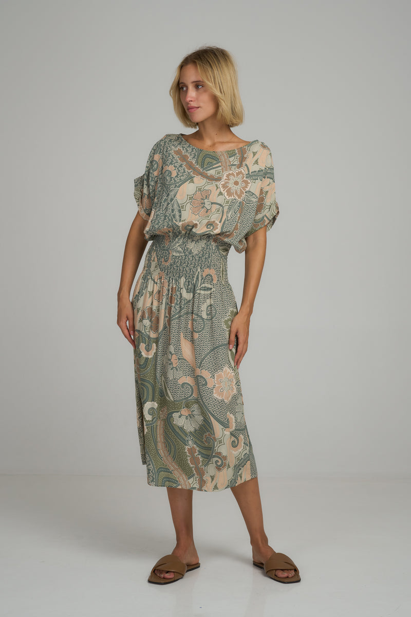 A model wearing a green batik casual midi dress