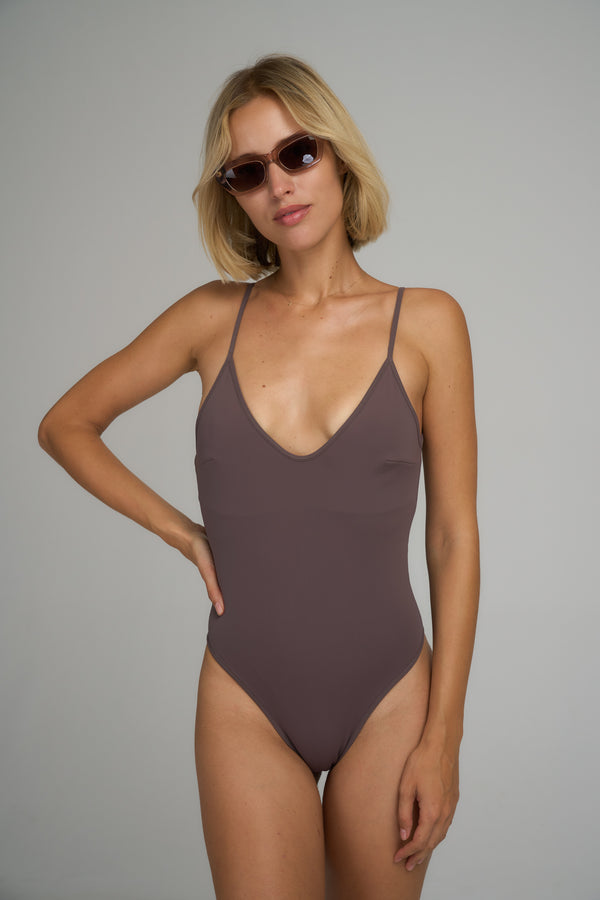 A model wearing a natural one piece swimsuit in Australia