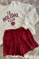 Flatlay of sating shorts in red with relaxed leg for summer styling
