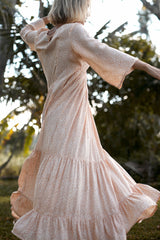 A model wearing a coral floral summer maxi dress