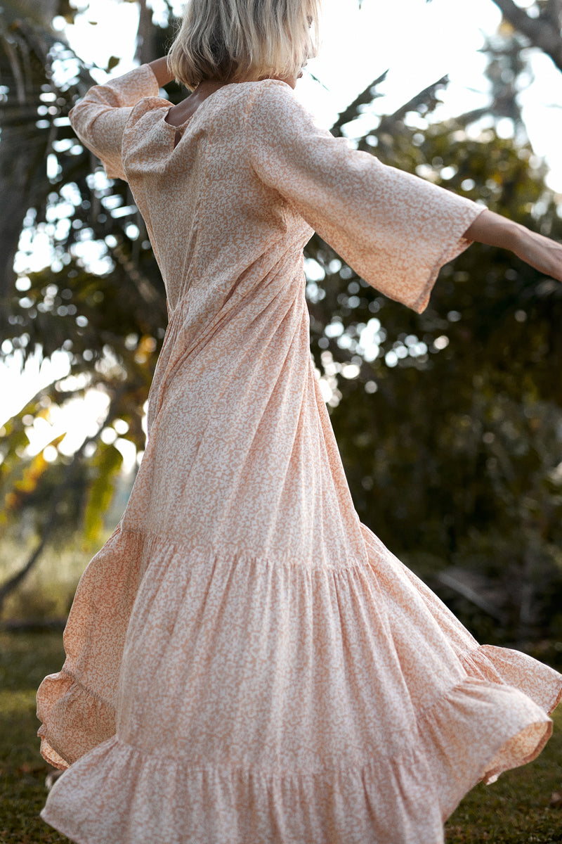 A model wearing a coral floral summer maxi dress