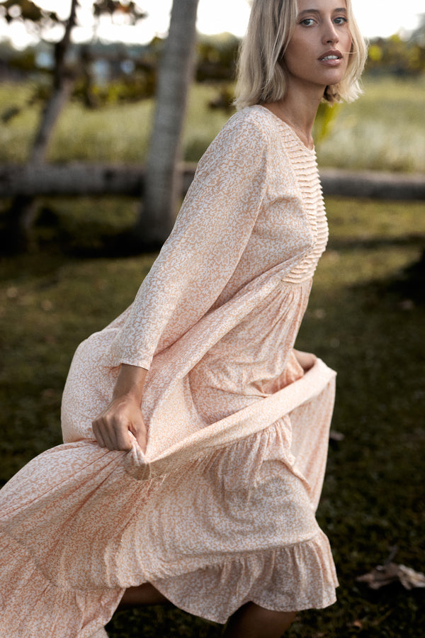 A model wearing a coral floral maxi dress