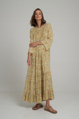 A Woman Wearing a Yellow Floral Maxi Dress with Pintuck Details