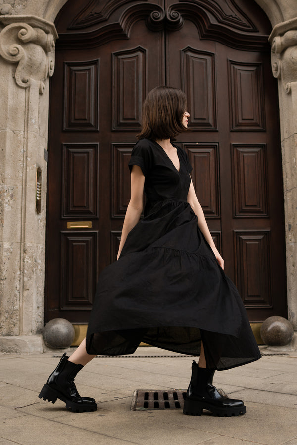Side view of a classic black maxi wrap dress