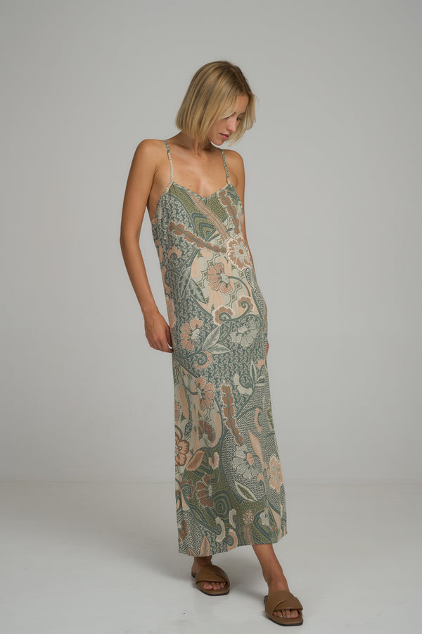 A model wearing a green floral maxi dress